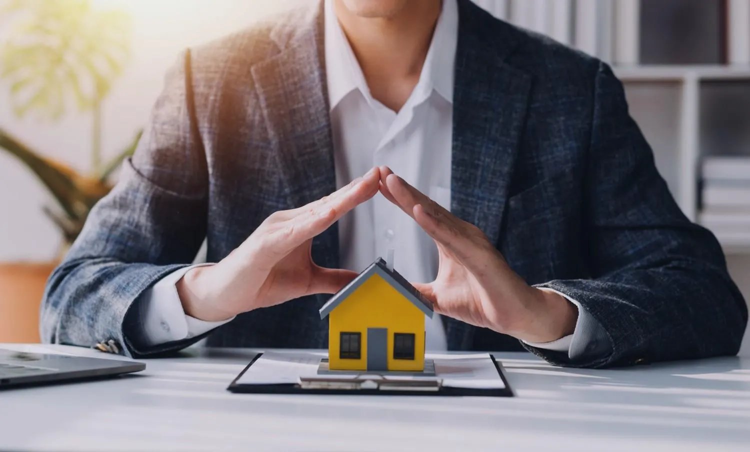 Homeowner holding keys in front of a house